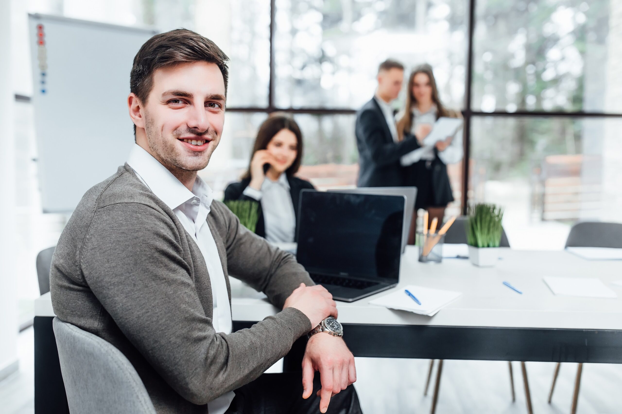 photo-successful-handsome-business-man-with-his-team-working-office About Us